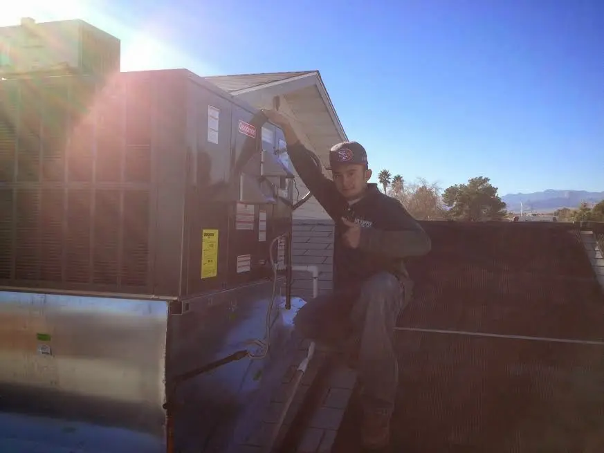 HVAC technician performing HVAC Inspection on a rooftop unit in Petal
